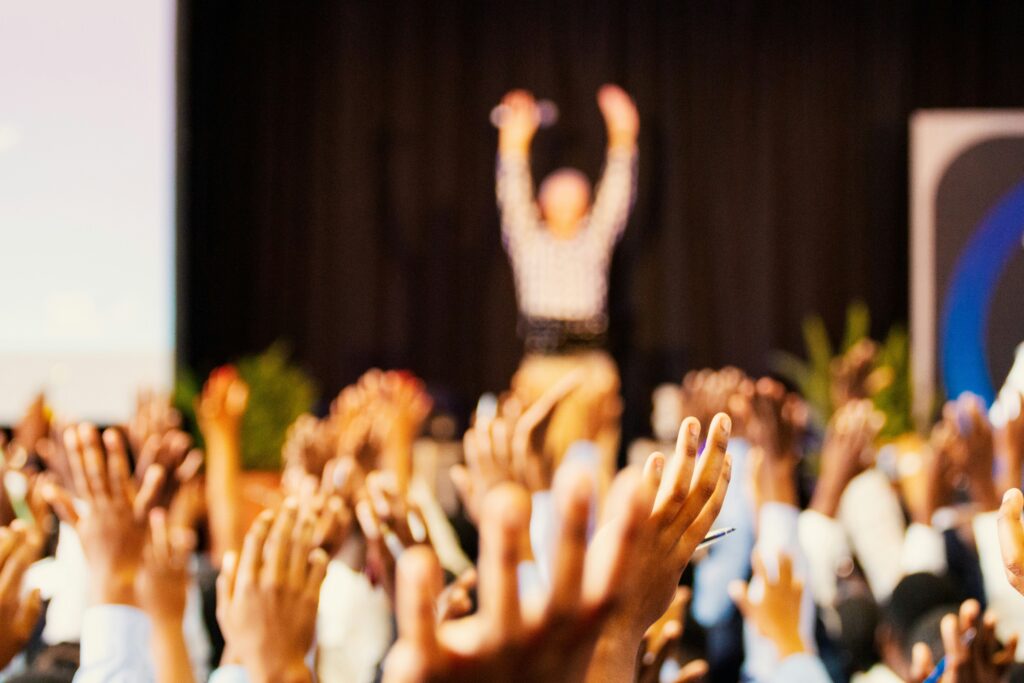 Hands raised up during an exercise at a conference.
